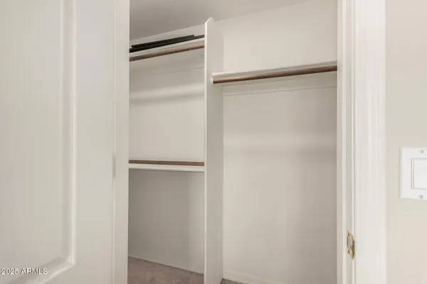 a view of a room with a fan and hardwood floor