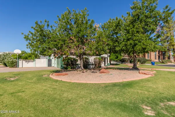 a backyard of a house with table and chairs