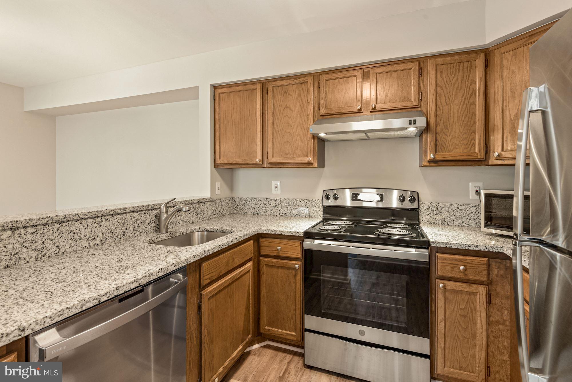 7825 Harrowgate Circle, Unit 142 Springfield, VA 22152 - Photo 15 of 38 Kitchen Overlooks Dining Area