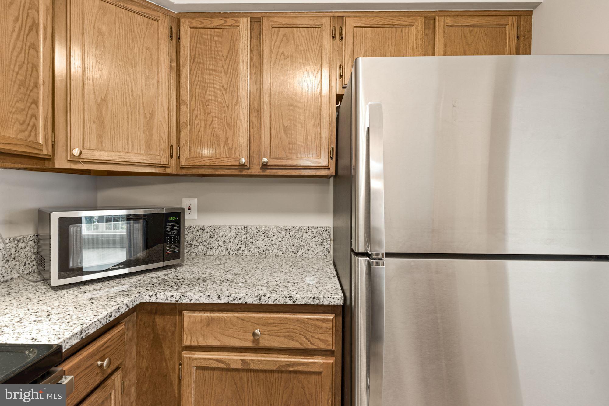 7825 Harrowgate Circle, Unit 142 Springfield, VA 22152 - Photo 19 of 38 Light Oak Cabinetry