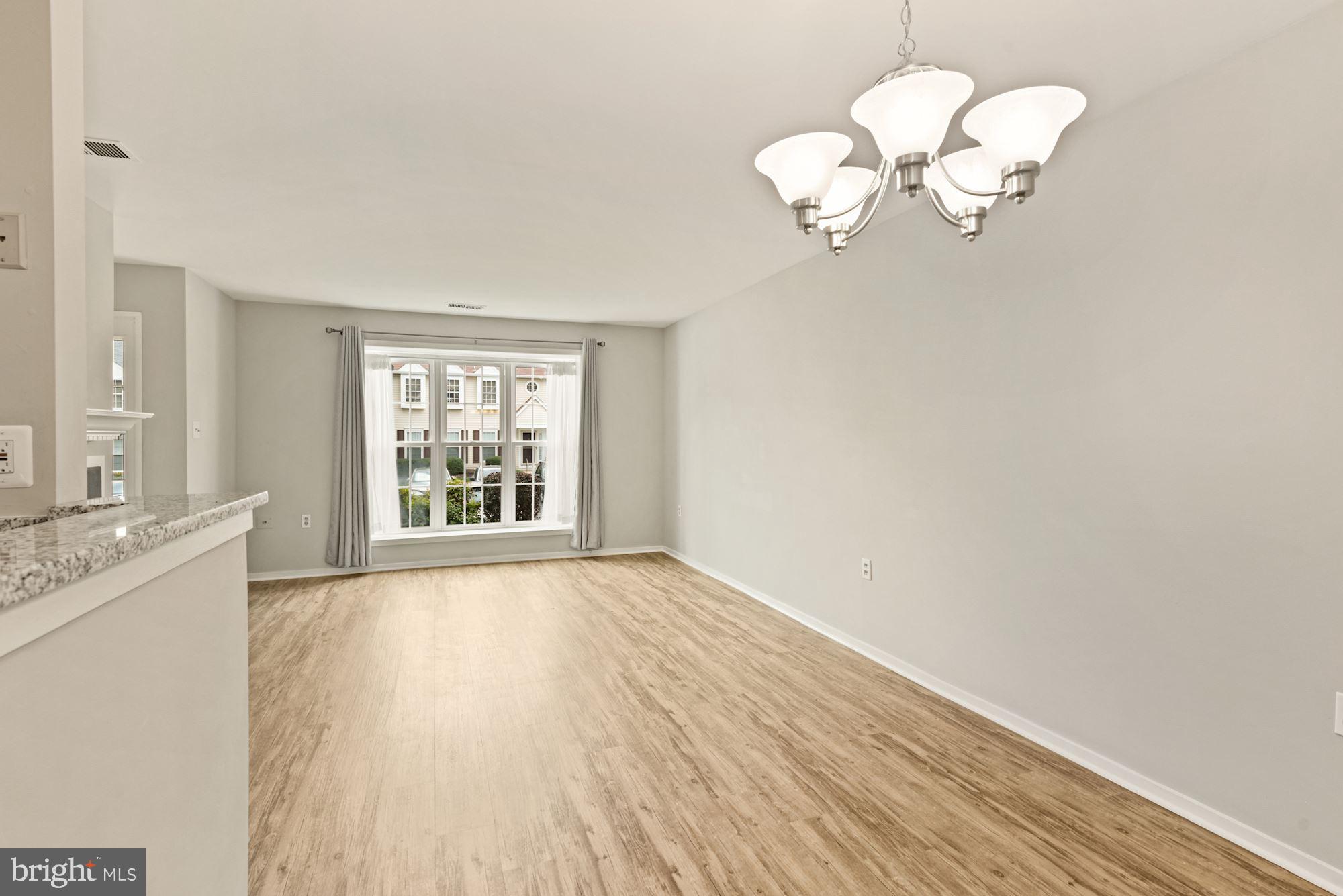 7825 Harrowgate Circle, Unit 142 Springfield, VA 22152 - Photo 22 of 38 Dining Area into Living Room