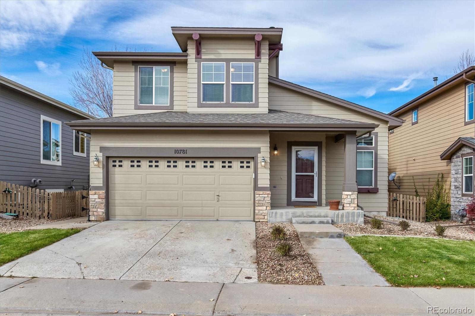 10781 Towerbridge Circle Highlands Ranch, CO 80130 - Photo 1 of 30 a front view of a house with a garden and entryway