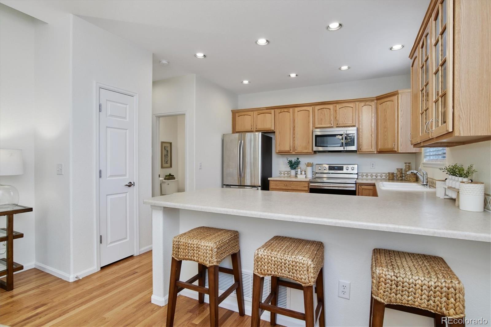 10781 Towerbridge Circle Highlands Ranch, CO 80130 - Photo 15 of 30 a kitchen with stainless steel appliances a microwave sink and refrigerator