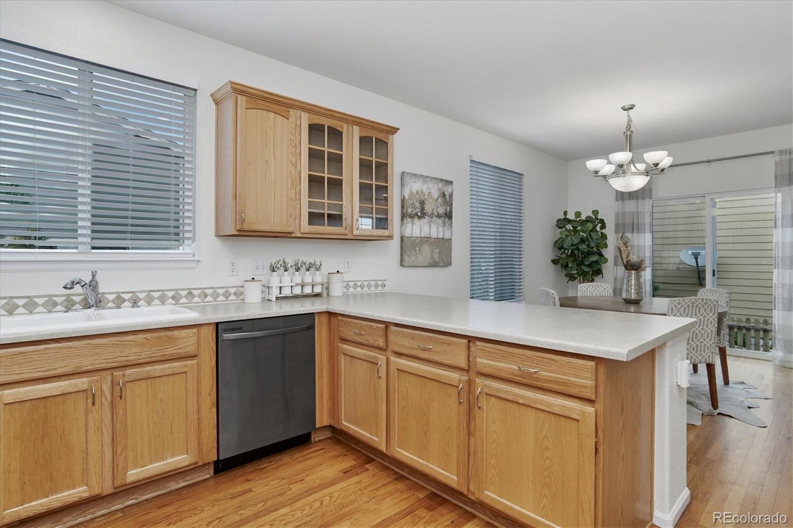 10781 Towerbridge Circle Highlands Ranch, CO 80130 - Photo 18 of 30 a kitchen with stainless steel appliances granite countertop a sink and cabinets
