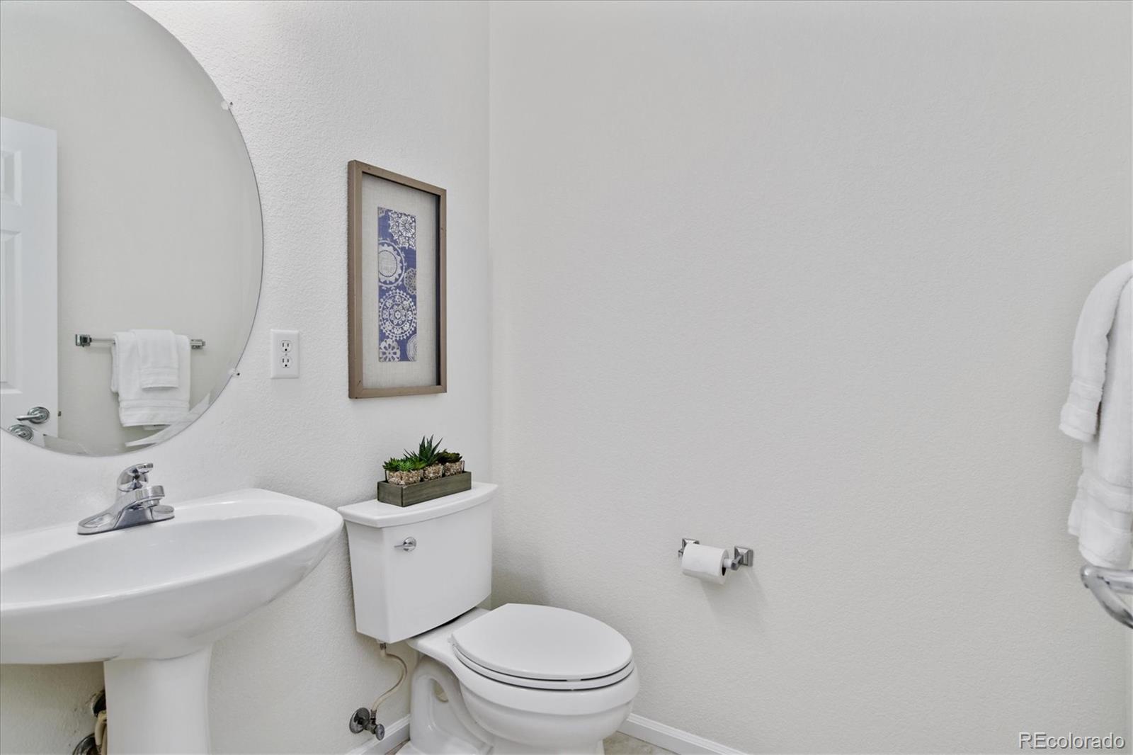 10781 Towerbridge Circle Highlands Ranch, CO 80130 - Photo 19 of 30 a bathroom with a sink mirror vanity and toilet