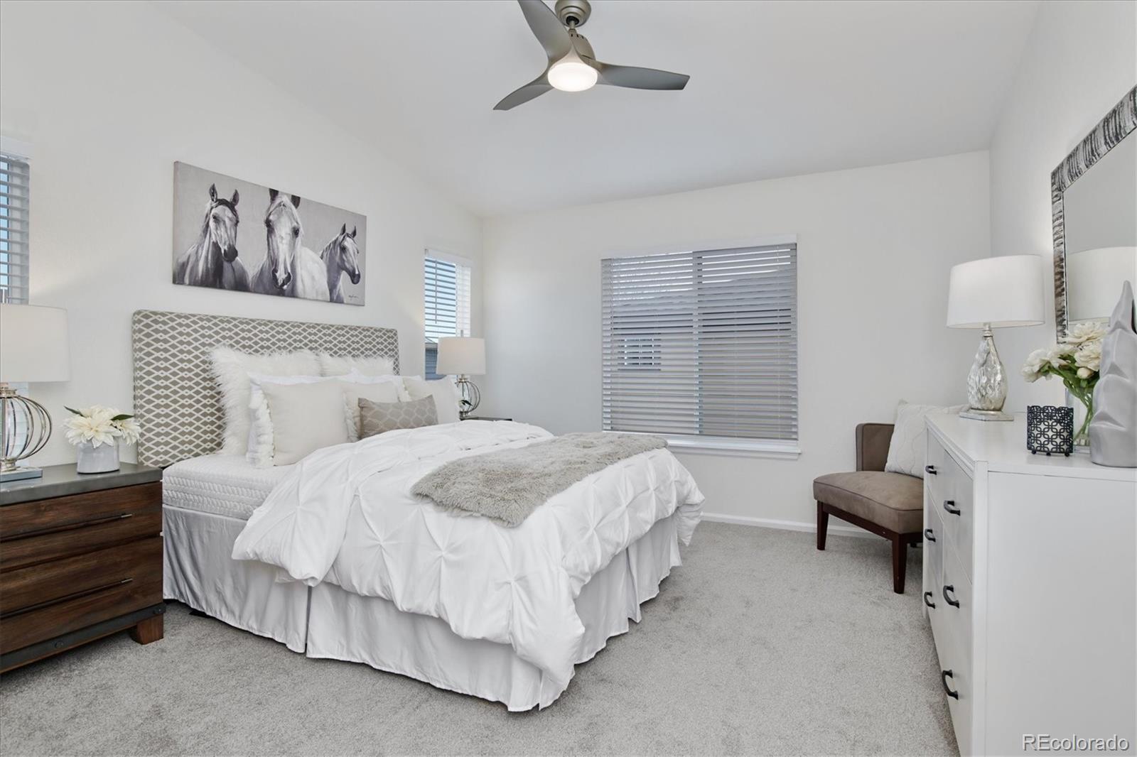 10781 Towerbridge Circle Highlands Ranch, CO 80130 - Photo 20 of 30 a spacious bedroom with a bed and a couch