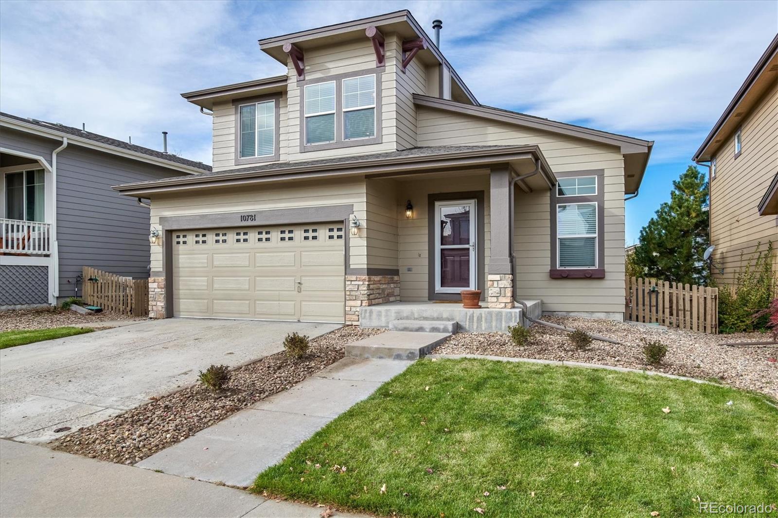 10781 Towerbridge Circle Highlands Ranch, CO 80130 - Photo 2 of 30 a front view of a house with garden