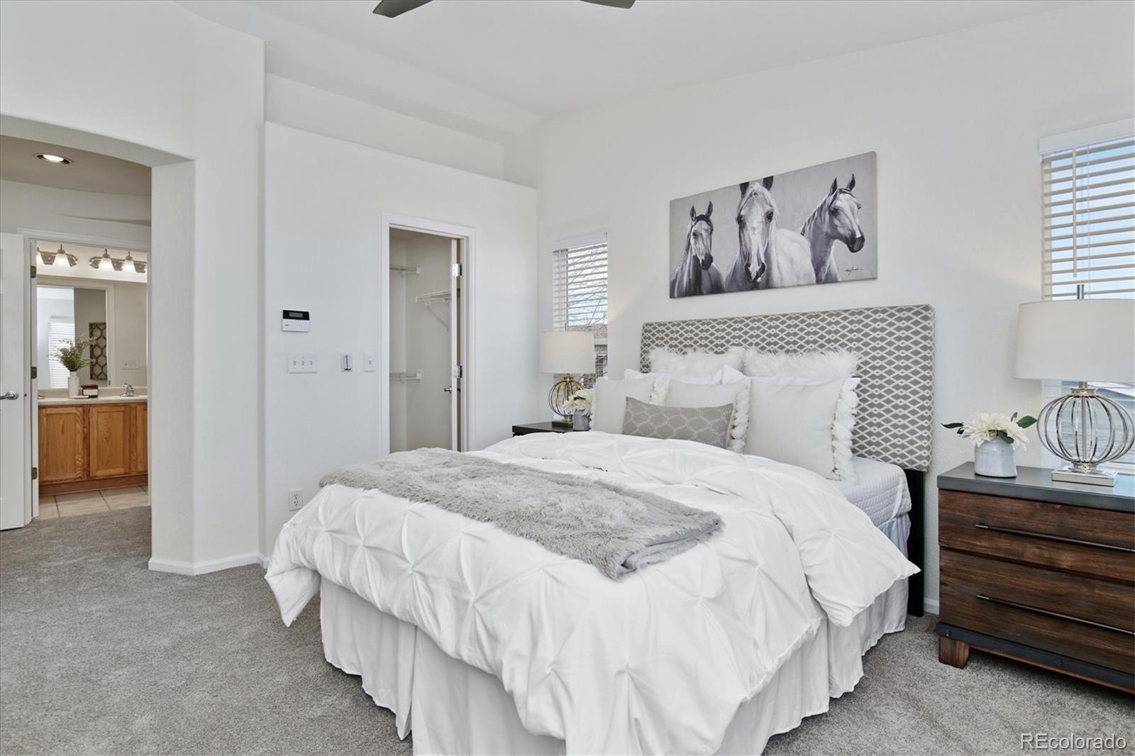 10781 Towerbridge Circle Highlands Ranch, CO 80130 - Photo 21 of 30 a bedroom with a bed and lamp