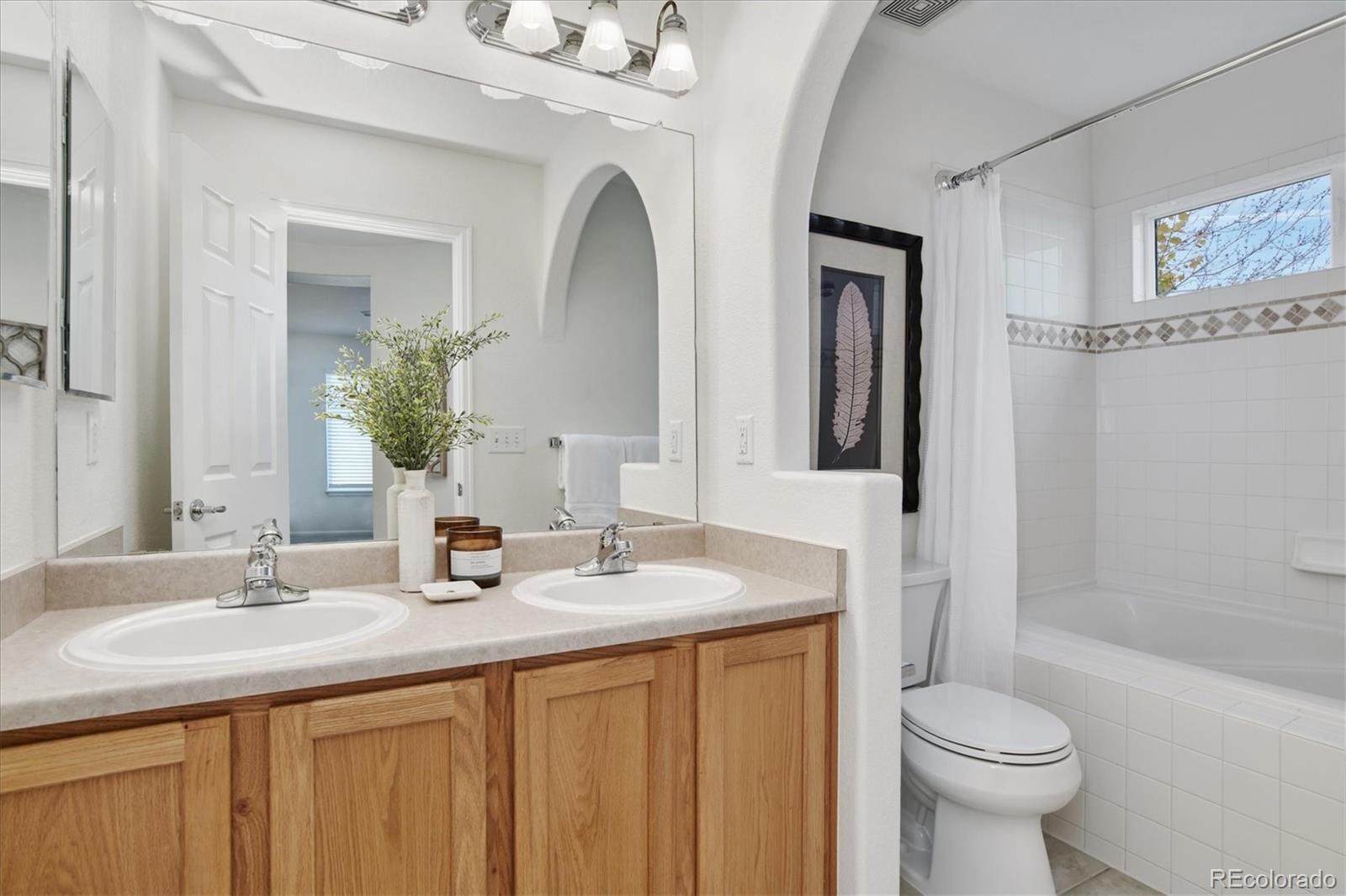 10781 Towerbridge Circle Highlands Ranch, CO 80130 - Photo 22 of 30 a bathroom with a sink a toilet and shower