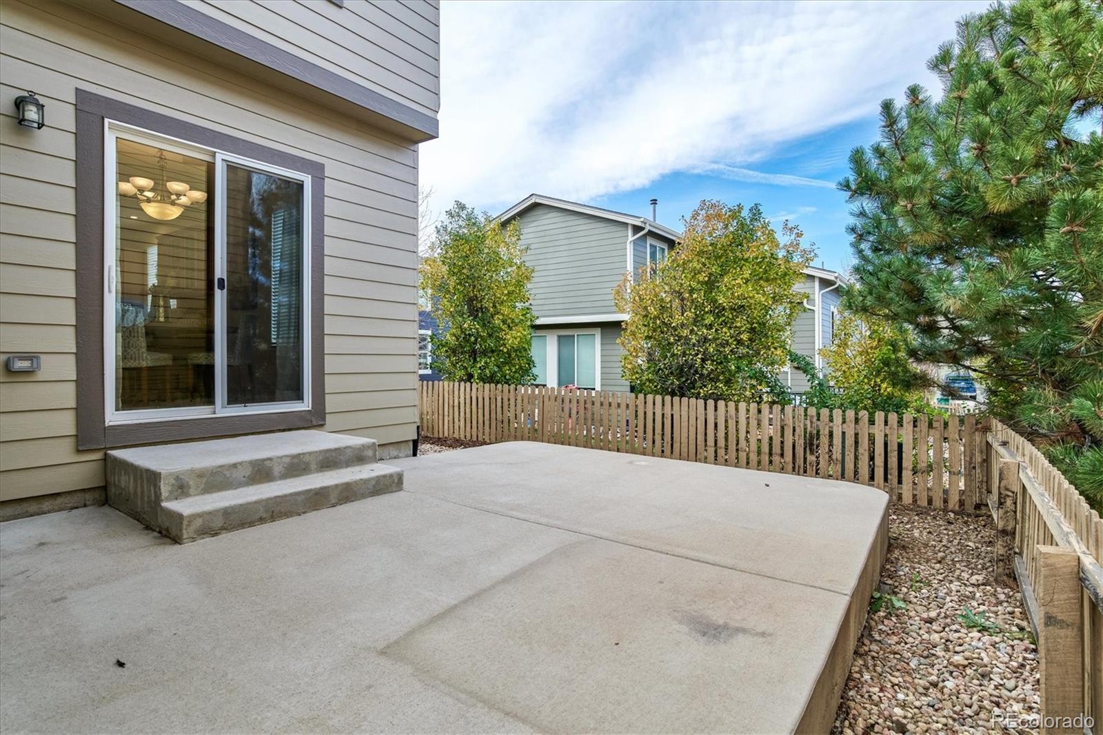 10781 Towerbridge Circle Highlands Ranch, CO 80130 - Photo 27 of 30 a view of a house with a wooden fence