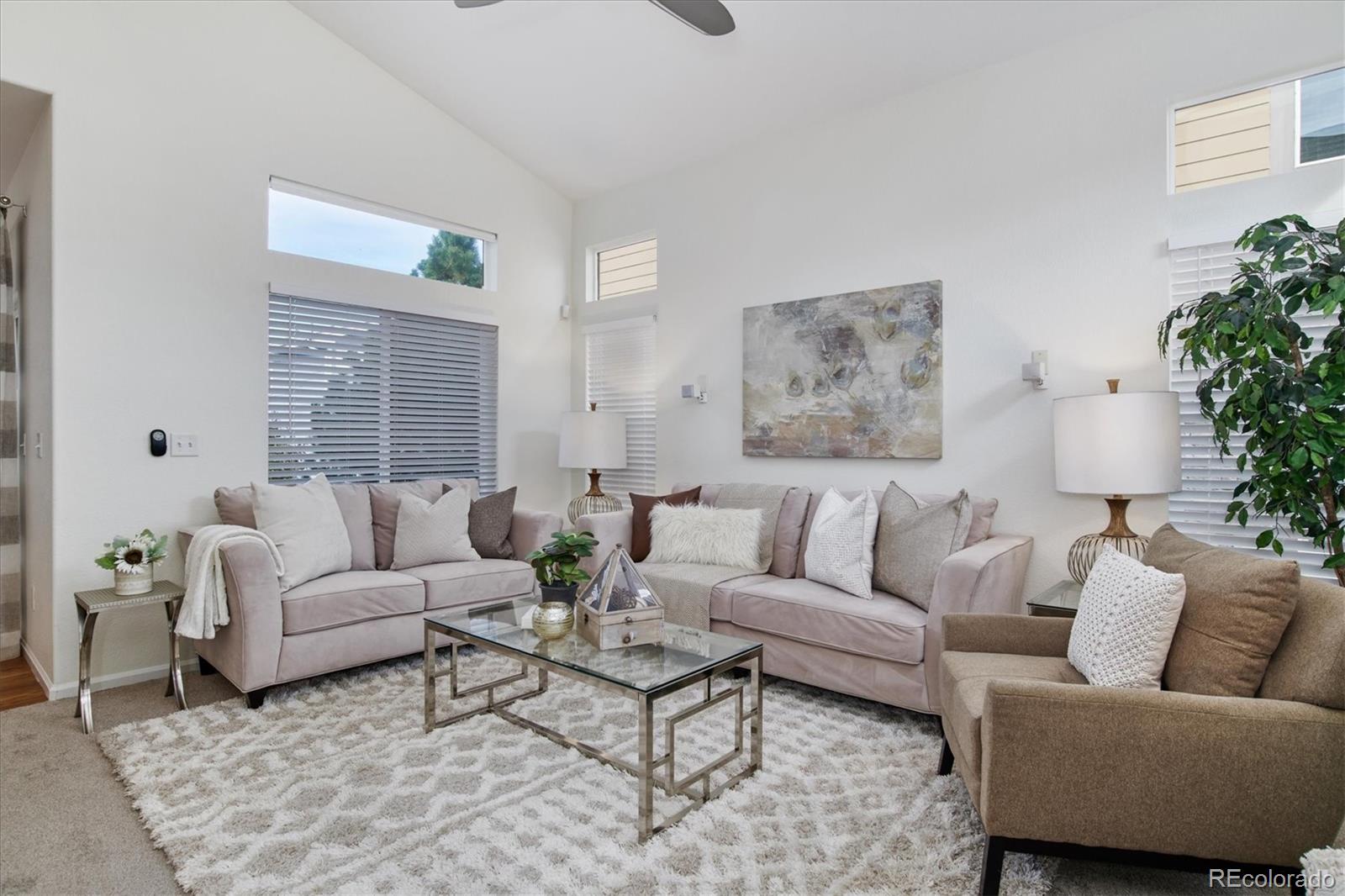 10781 Towerbridge Circle Highlands Ranch, CO 80130 - Photo 5 of 30 a living room with furniture and a large window
