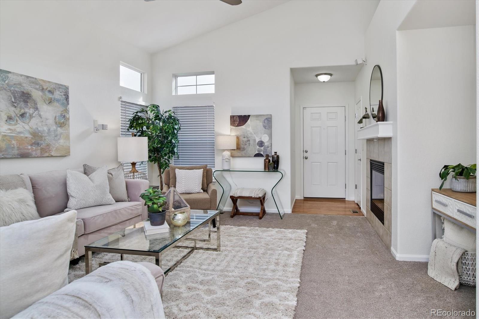 10781 Towerbridge Circle Highlands Ranch, CO 80130 - Photo 8 of 30 a living room with furniture and a chandelier