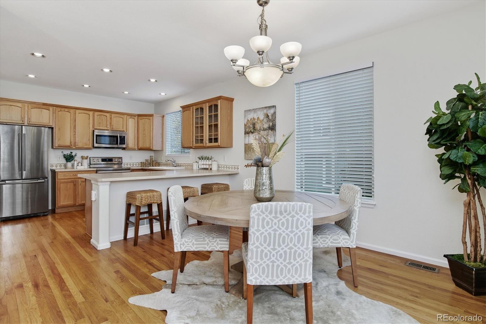 10781 Towerbridge Circle Highlands Ranch, CO 80130 - Photo 10 of 30 a view of a dining room with furniture window and wooden floor