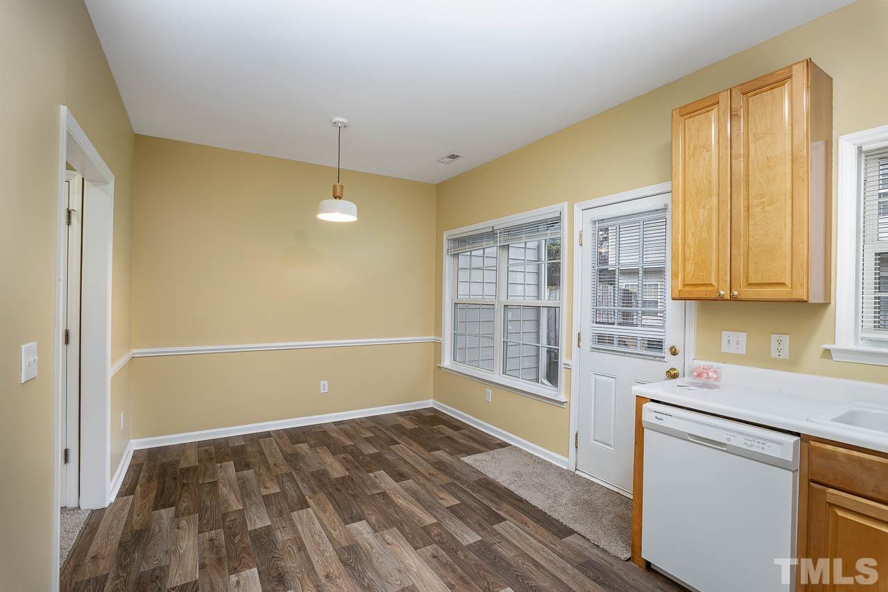 209 Dairy Road Clayton, NC 27520 - Photo 19 of 34 a kitchen with a wooden floor and a window