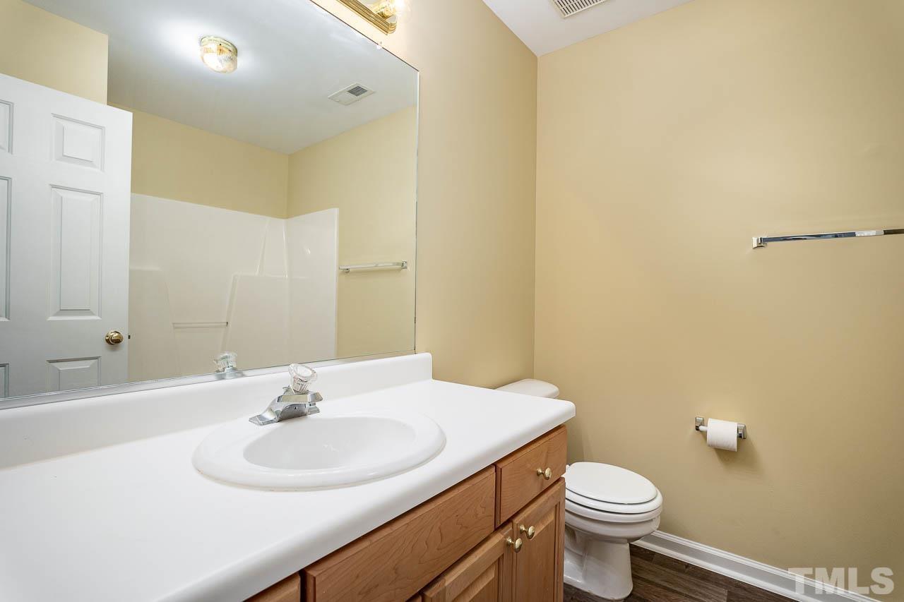 209 Dairy Road Clayton, NC 27520 - Photo 28 of 34 a bathroom with a sink and a toilet