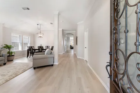 a living room with furniture and a chandelier