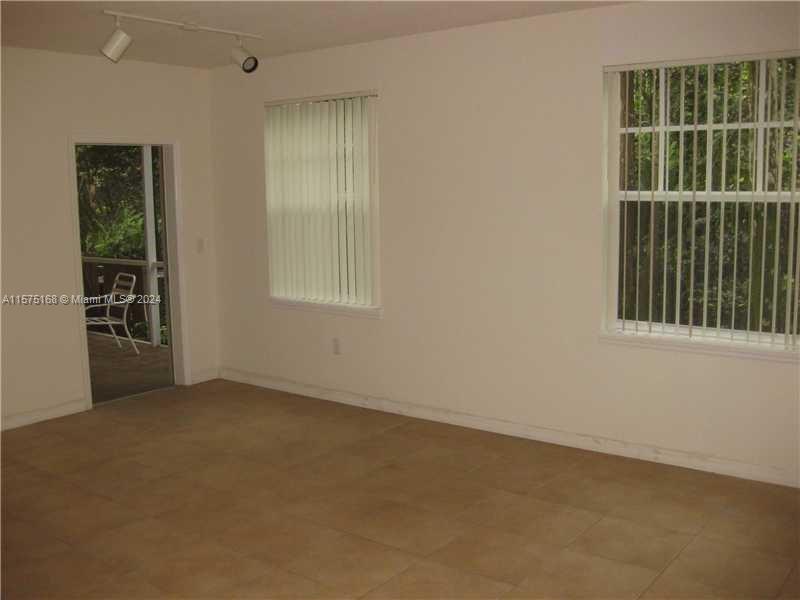 6894 West Sample Road, Unit 6894 Coral Springs, FL 33067 - Photo 13 of 18 an empty room with windows
