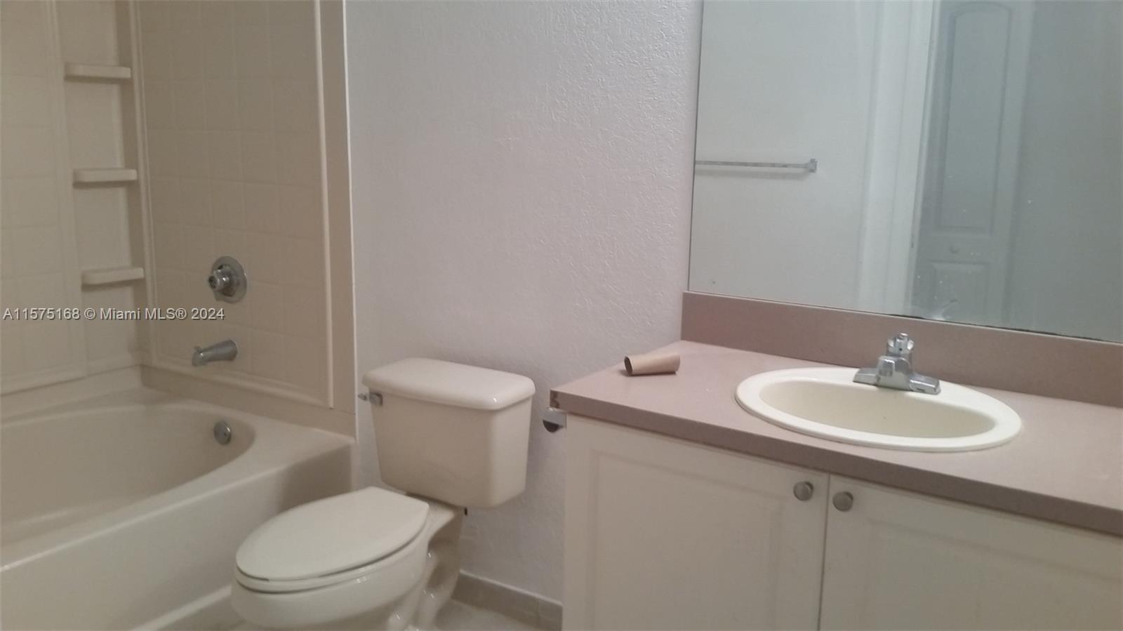 6894 West Sample Road, Unit 6894 Coral Springs, FL 33067 - Photo 10 of 18 a bathroom with a sink toilet and bathtub