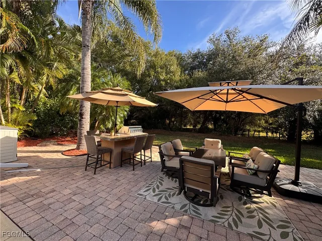 a view of backyard with outdoor seating a patio and a garden