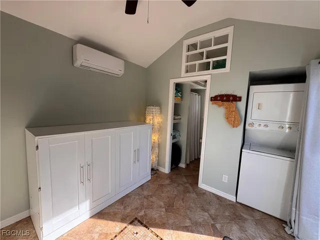 a view of a storage & utility room with a fridge