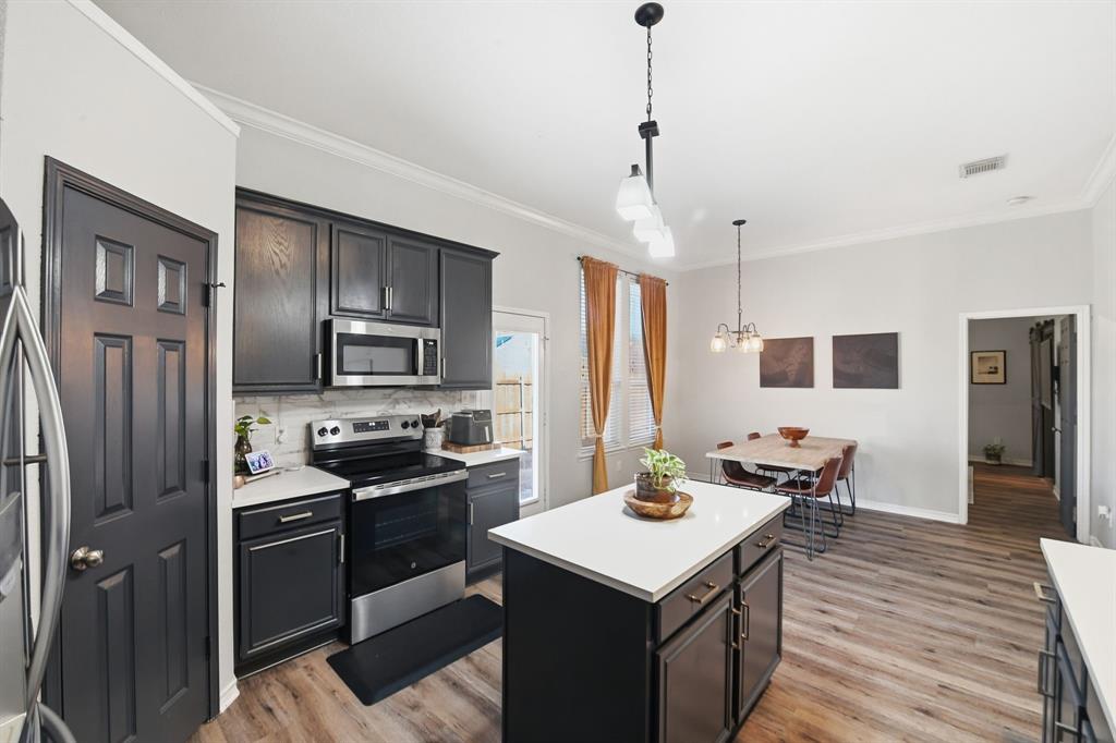 3701 Fiscal Court Fort Worth, TX 76244 - Photo 11 of 29 a kitchen with a refrigerator a sink dishwasher a stove and a refrigerator with wooden floor