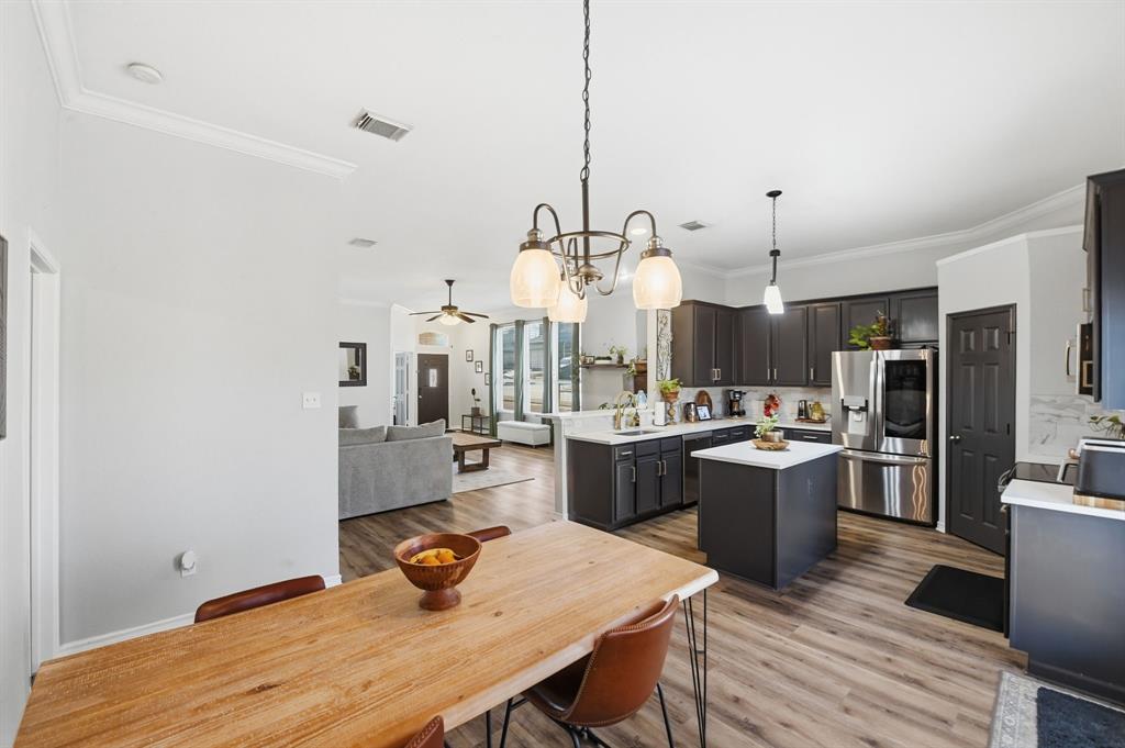 3701 Fiscal Court Fort Worth, TX 76244 - Photo 13 of 29 a kitchen with a table chairs and wooden floor