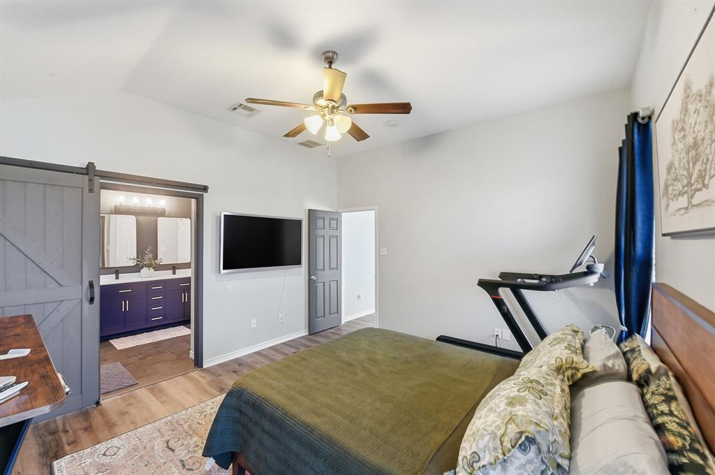 3701 Fiscal Court Fort Worth, TX 76244 - Photo 16 of 29 a bedroom with a bed and a flat screen tv