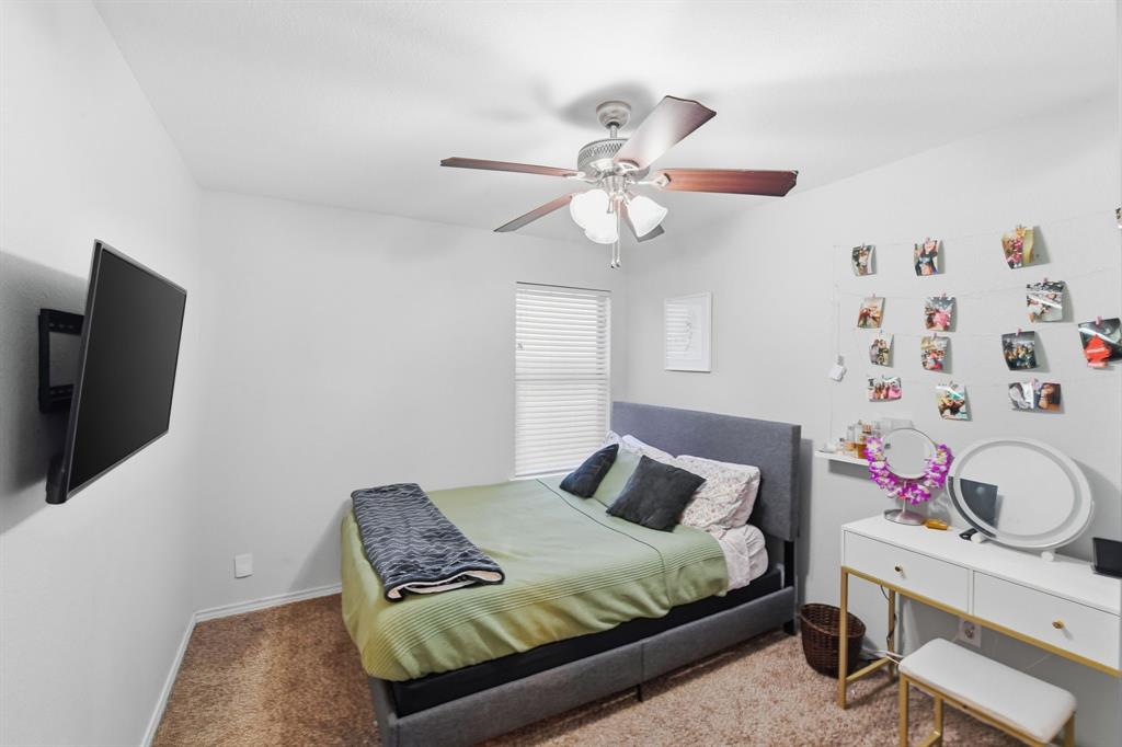 3701 Fiscal Court Fort Worth, TX 76244 - Photo 22 of 29 a bedroom with a bed and a flat screen tv