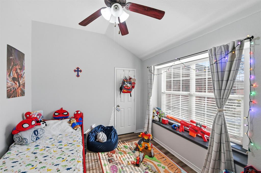 3701 Fiscal Court Fort Worth, TX 76244 - Photo 24 of 29 a bedroom with a bed and a chandelier