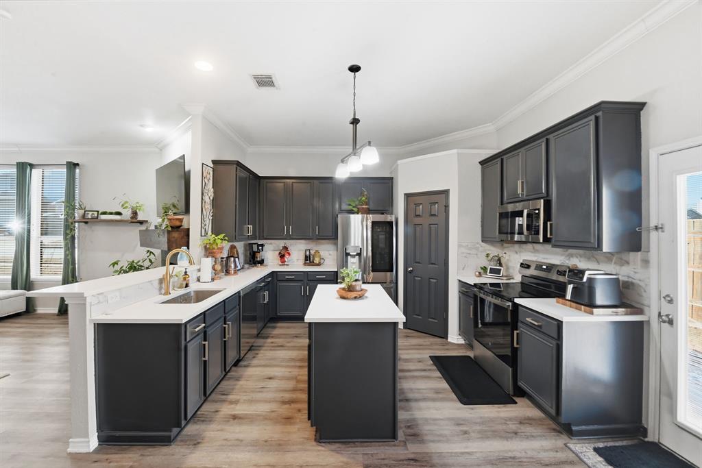 3701 Fiscal Court Fort Worth, TX 76244 - Photo 8 of 29 a kitchen with stainless steel appliances granite countertop a sink stove and refrigerator