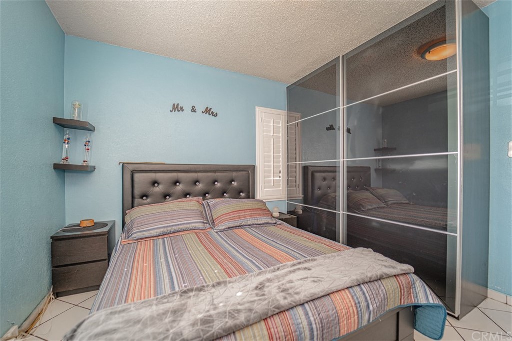 2228 Northside Drive Montebello, CA 90640 - Photo 19 of 49 a bedroom with a bed and a mirror