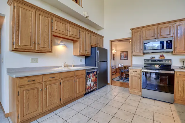 a kitchen with stainless steel appliances granite countertop a sink and cabinets
