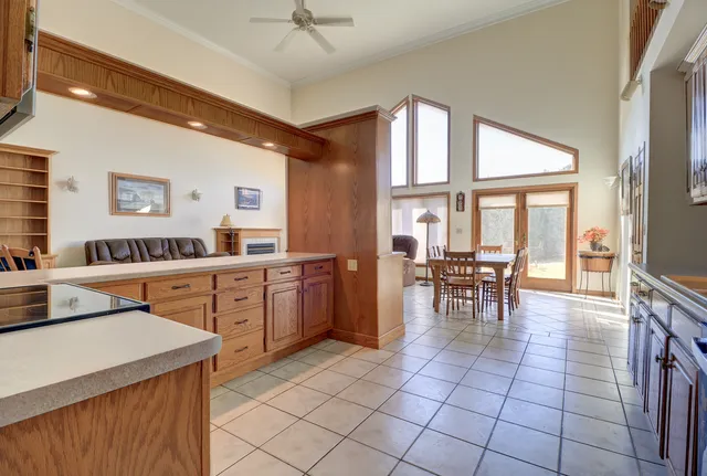 a view of a dining room with furniture large windows and wooden floor