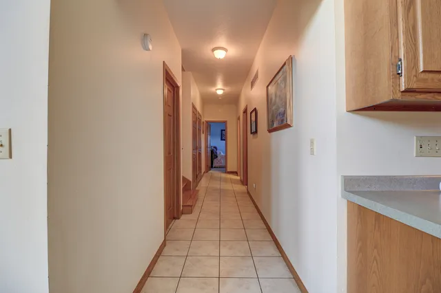 a spacious bathroom with a granite countertop sink a mirror and a bathtub