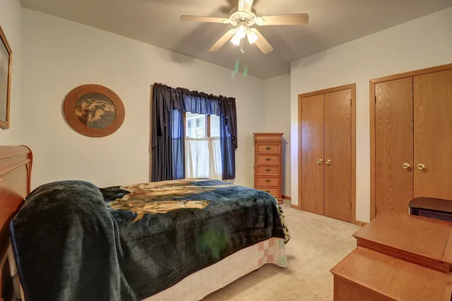 a bedroom with bed and window