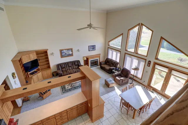a living room with lots of furniture and a book shelf