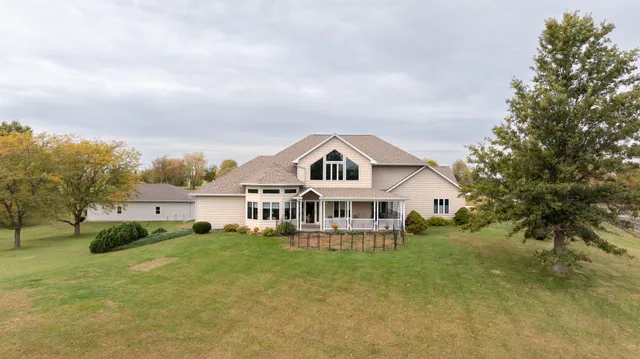 an aerial view of a house with a yard