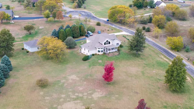 a view of a house with a yard and potted plants
