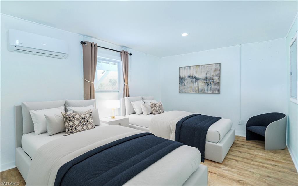 12277 Boat Shell Drive Matlacha Isles, FL 33991 - Photo 34 of 46 a bedroom with two beds and a painting