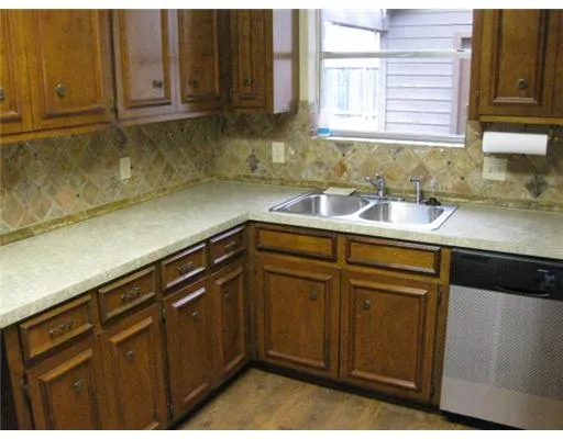 a kitchen with a sink and cabinets
