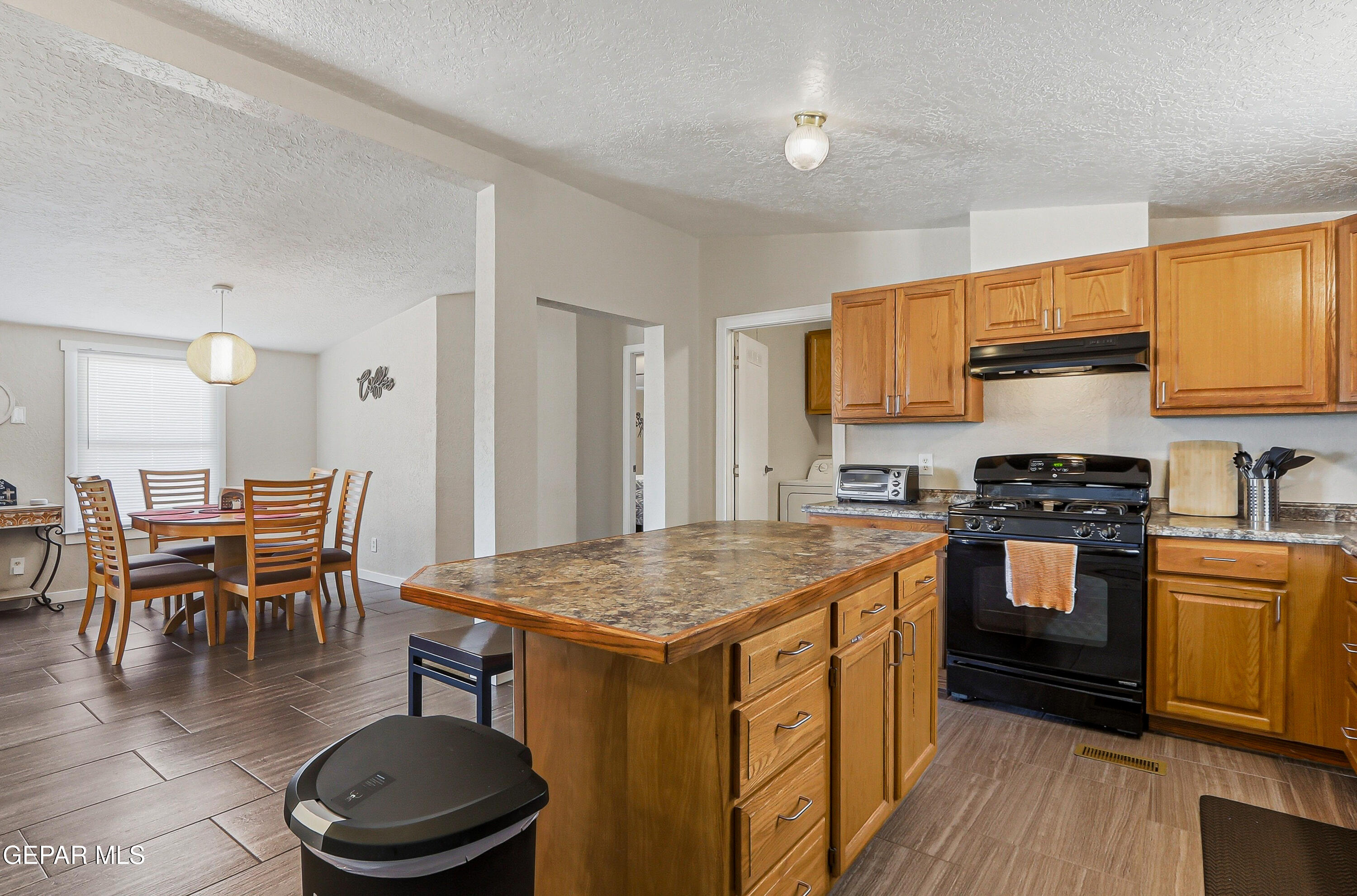 2901 Cook Street Truth or Consequences, NM 87901 - Photo 8 of 31 a kitchen with a stove a sink a dining table and chairs