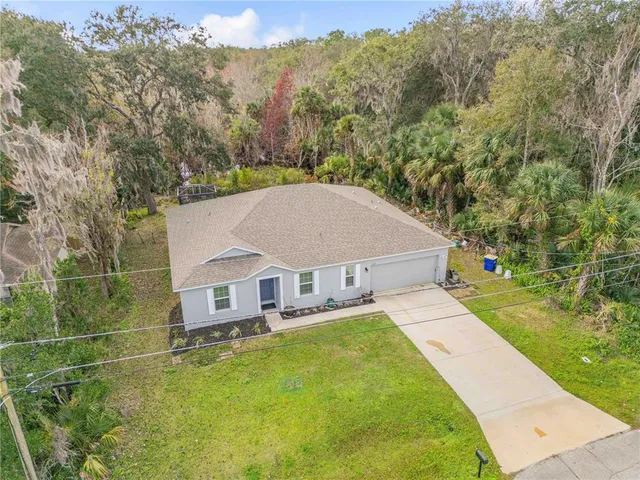 a view of a house with pool and a yard