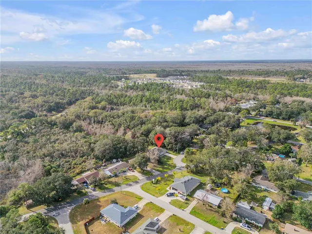 an aerial view of a houses with city view