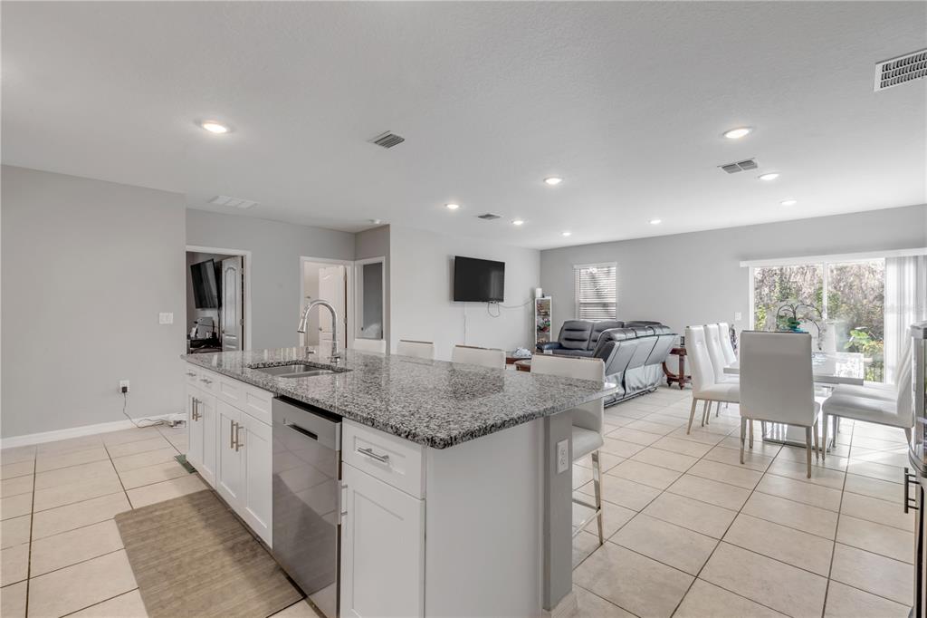 1017 36th Street Edgewater, FL 32141 - Photo 6 of 29 a view of center island table and chairs