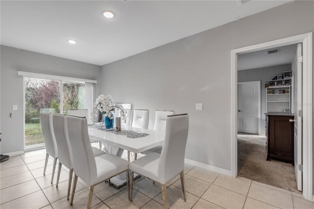 1017 36th Street Edgewater, FL 32141 - Photo 10 of 29 a dining room with furniture and a floor to ceiling window