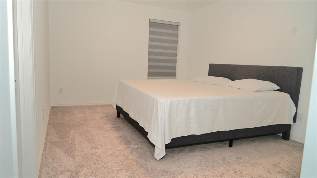 502 Virginia Way Princeton, TX 75407 - Photo 7 of 9 Neutral-toned carpeting paired with light walls