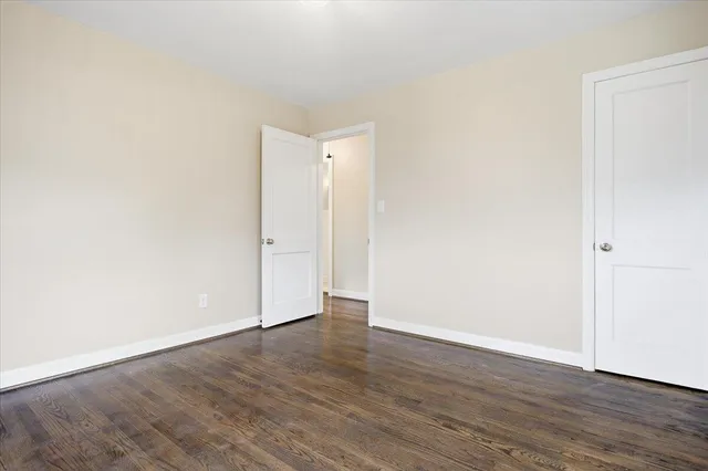 an empty room with wooden floor