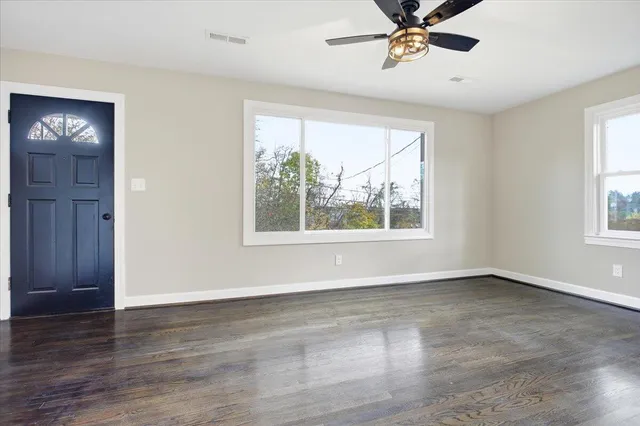 wooden floor in an empty room with a window
