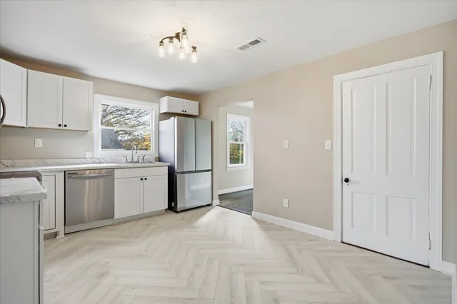 a view of a kitchen with electric appliances