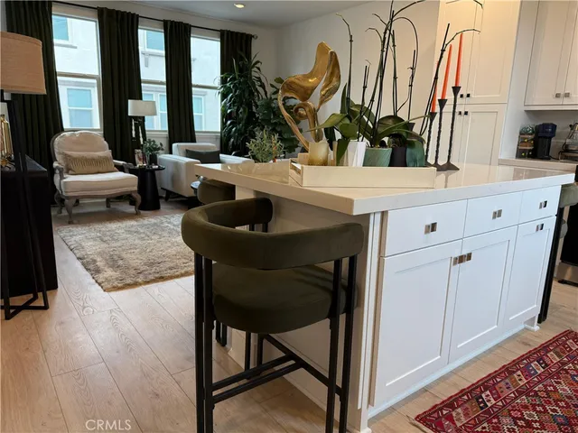 a living room with furniture a large window and flat screen tv